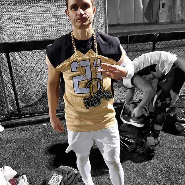 Football player wearing a custom turnover chain after a big play.
